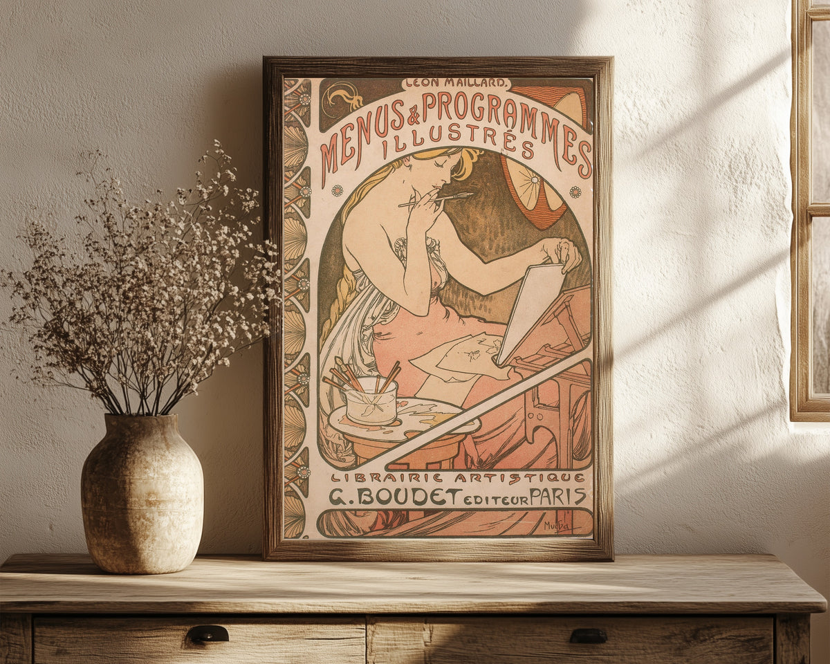 Framed art print of Menus et Programmes illustrés by Alphonse Mucha, in a dark wood frame leaning on a rustic console beside dried flowers