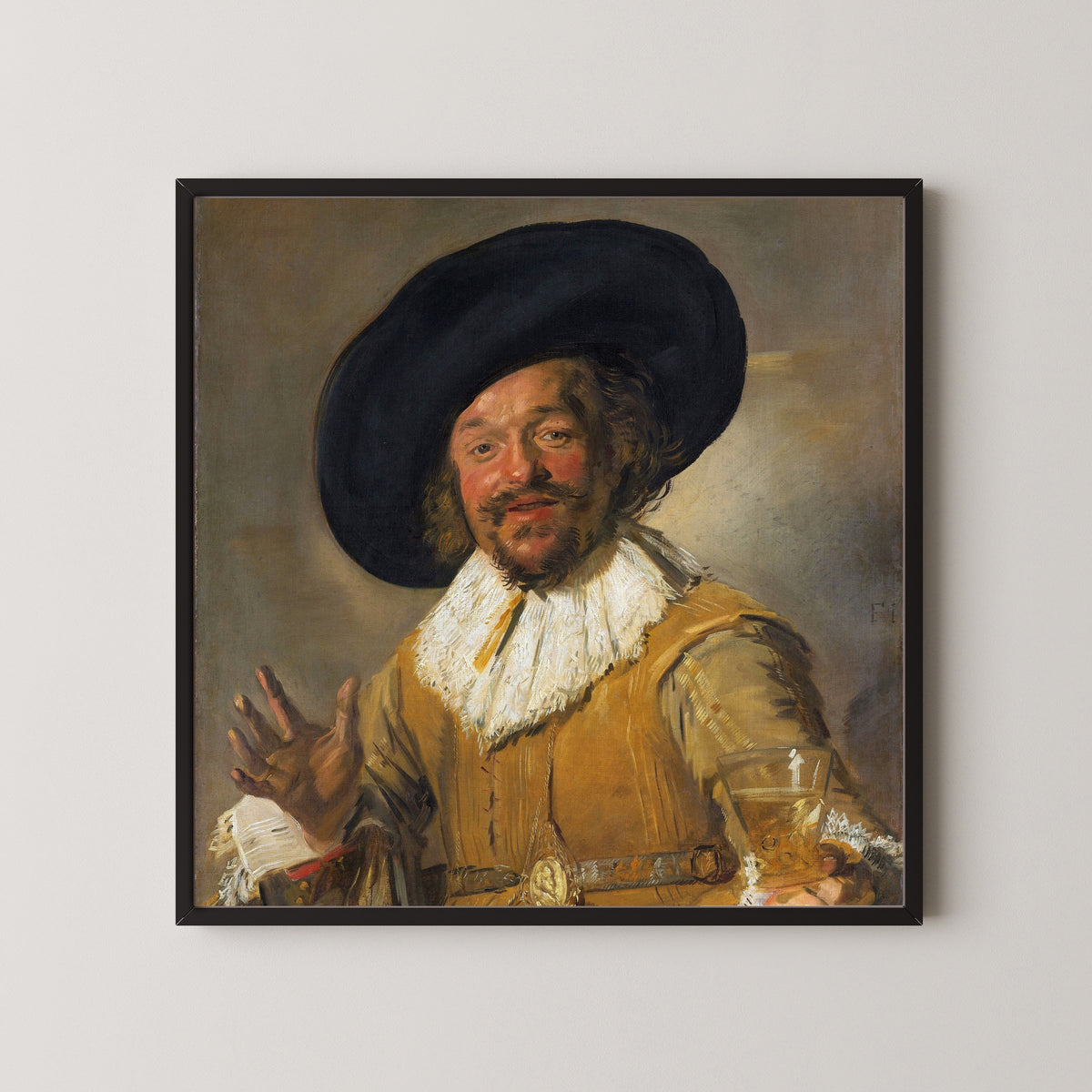 Framed art print of Merry Drinker by Frans Hals, in a black frame on a pale wall