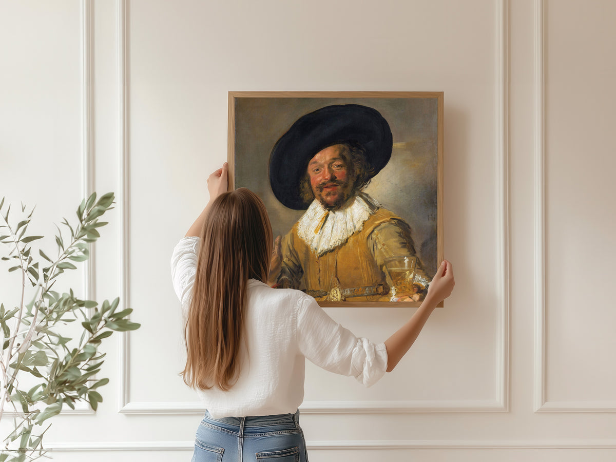 Framed art print of Merry Drinker by Frans Hals, hung on a panelled wall