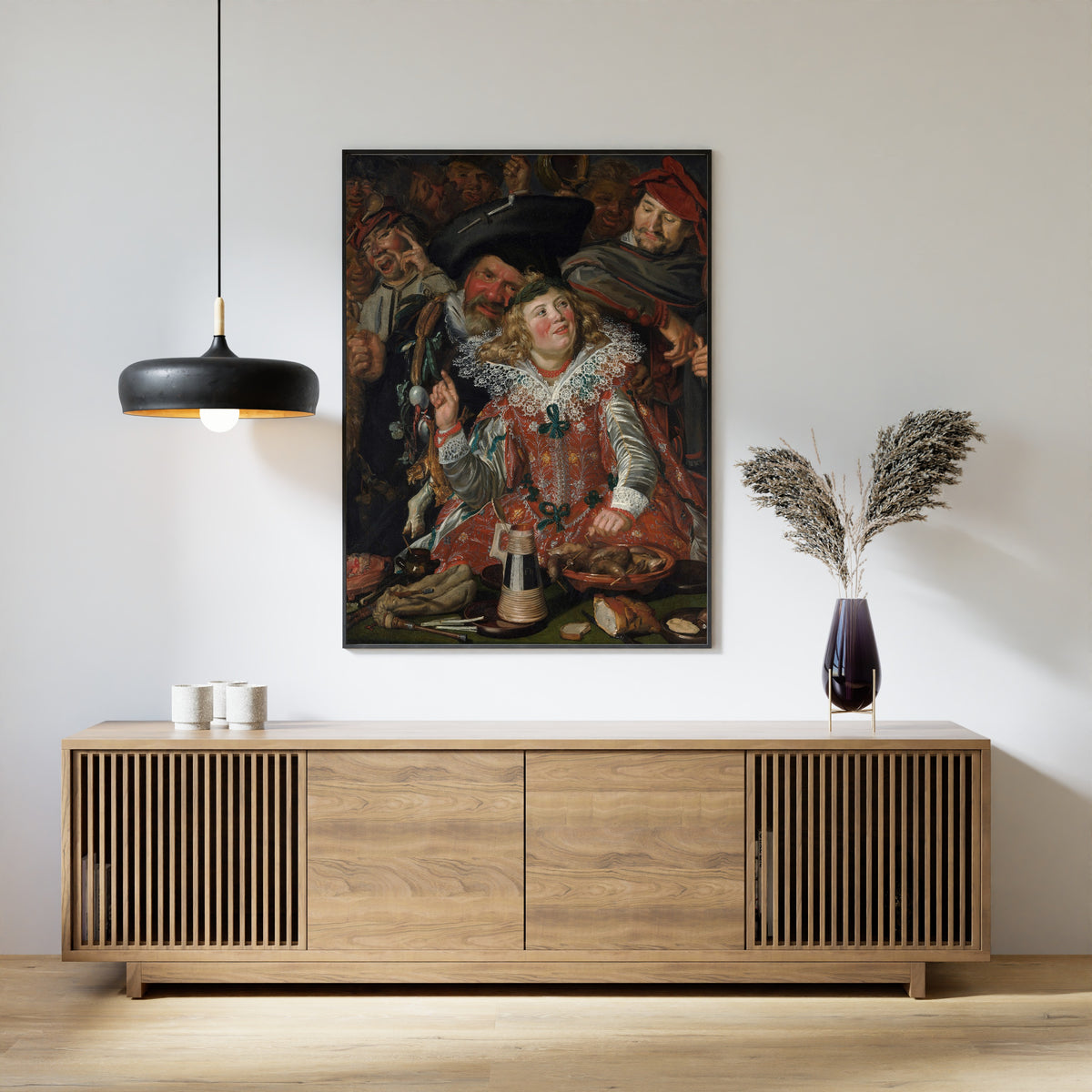 Framed art print of Merrymakers at Shrovetide by Frans Hals, above a slatted wood sideboard