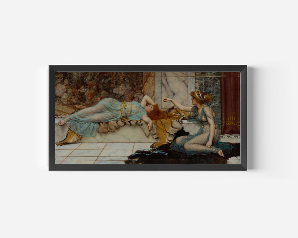 Framed art print of Mischief and Repose by John William Godward, in a wide black frame on a plain white wall