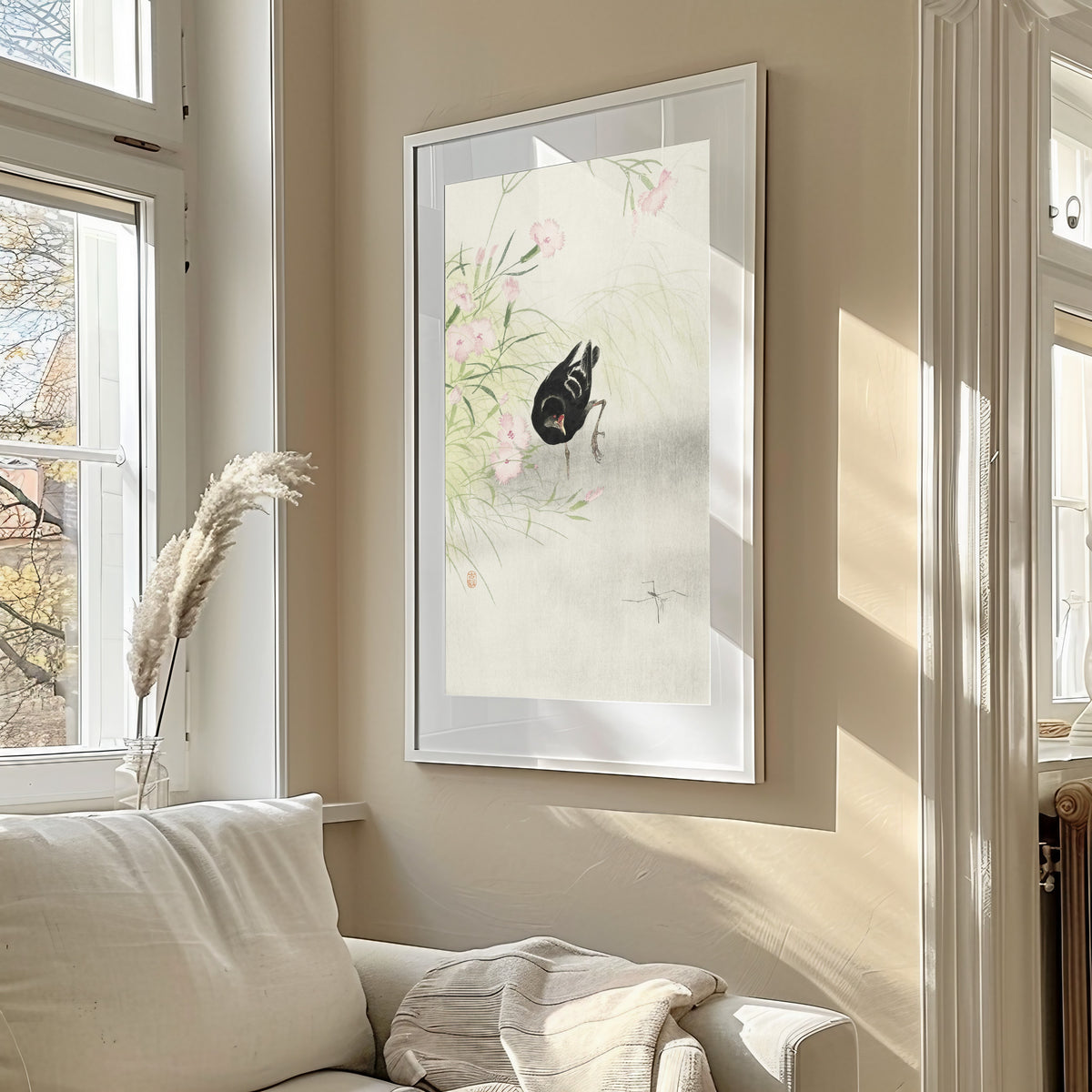 Framed art print of Moorhen at a Flowering Plant by Ohara Koson, in a sunlit living room above a sofa