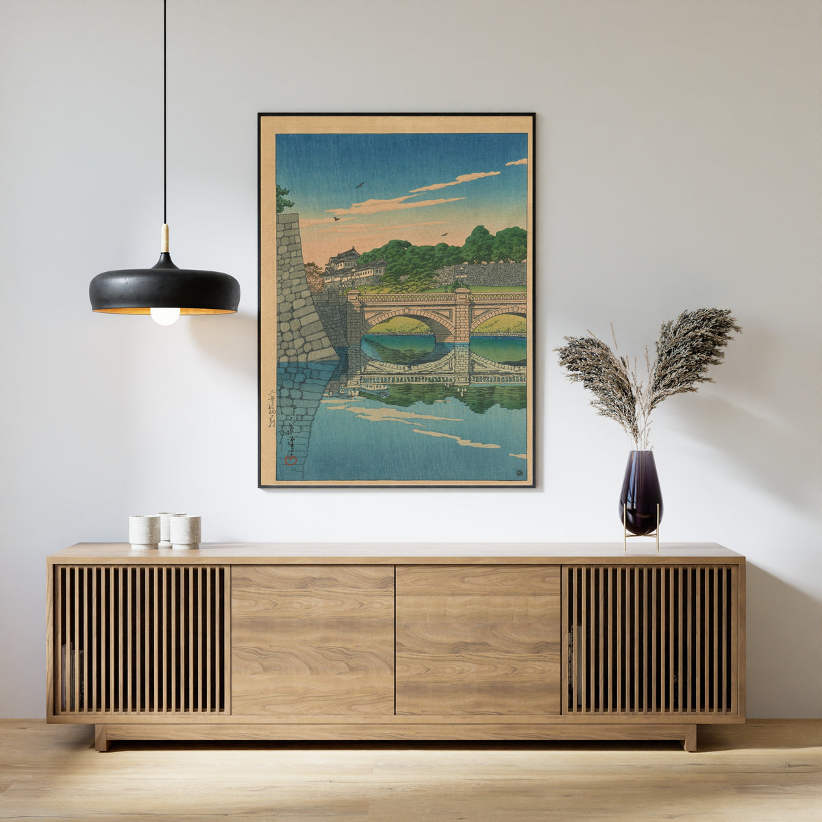 Framed art print of Morning at Nijū Bridge by Kawase Hasui, above a slatted wood sideboard
