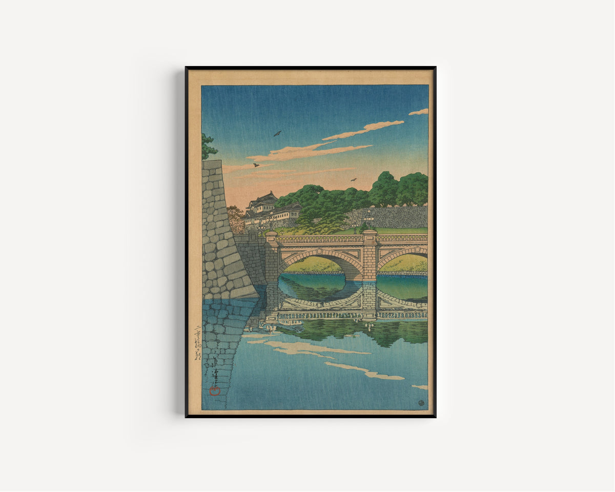 Framed art print of Morning at Nijū Bridge by Kawase Hasui, in a slim black frame on a plain white wall