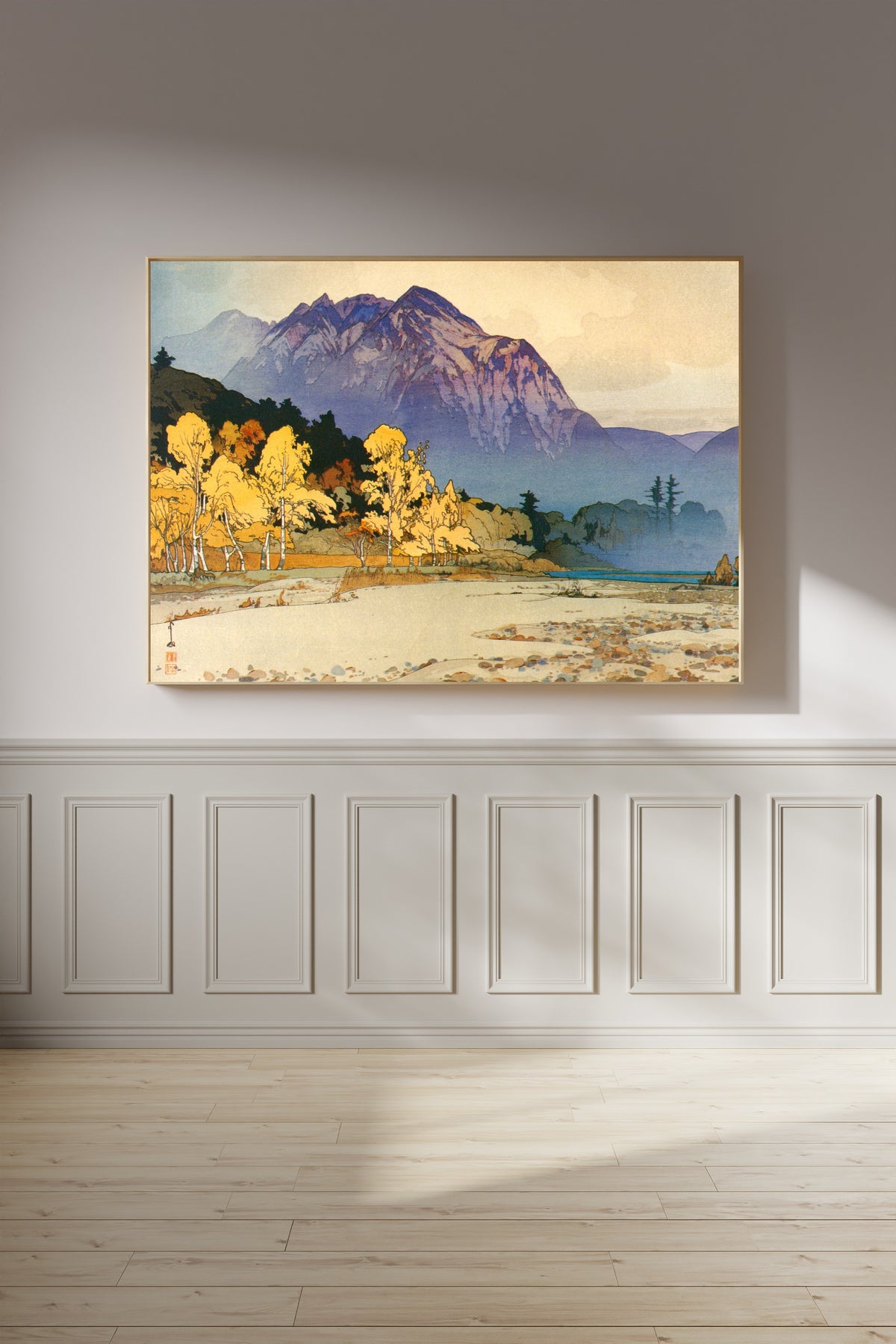 Framed art print of Mount Hodaka after Rain by Hiroshi Yoshida, on a panelled wall in afternoon light