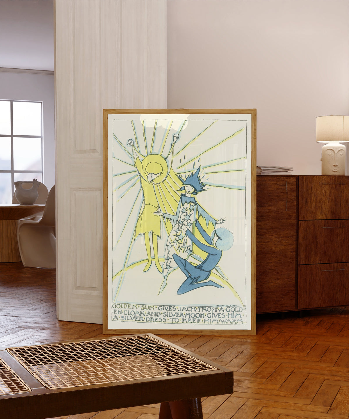 Framed art print of Mummy's Bedtime Story Book: Golden Sun Gives Jack… by Jessie M. King, in a light wood frame leaning in a warm room with a parquet floor
