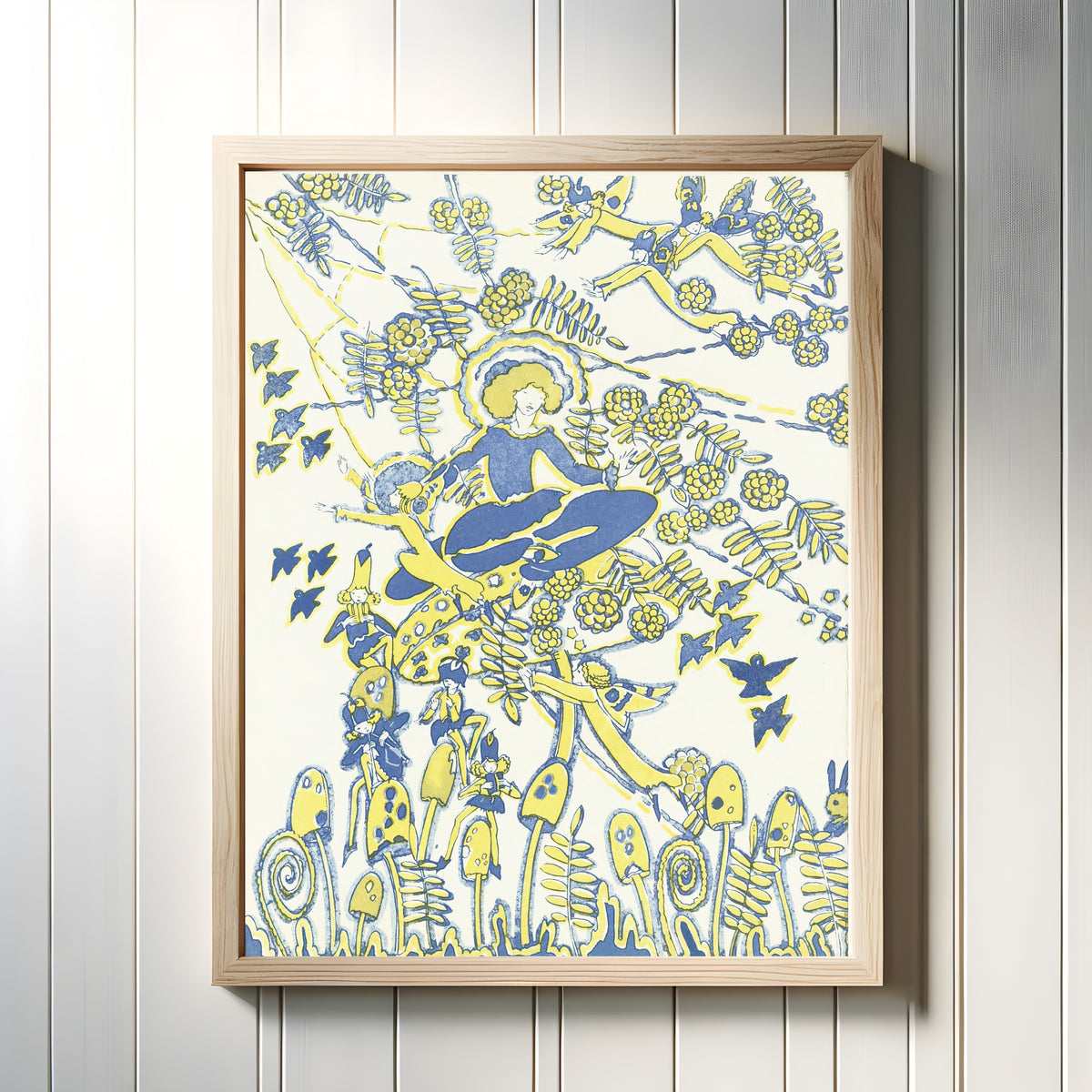 Framed art print of Mummy's Bedtime Story Book: Plate 7 by Jessie M. King, in a light wood frame on a white panelled wall