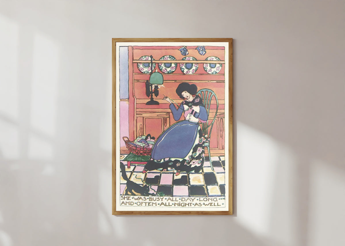 Framed art print of Mummy's Bedtime Story Book: She Was Busy All Day Long and Often All Night… by Jessie M. King, in a light wood frame on a sunlit white wall