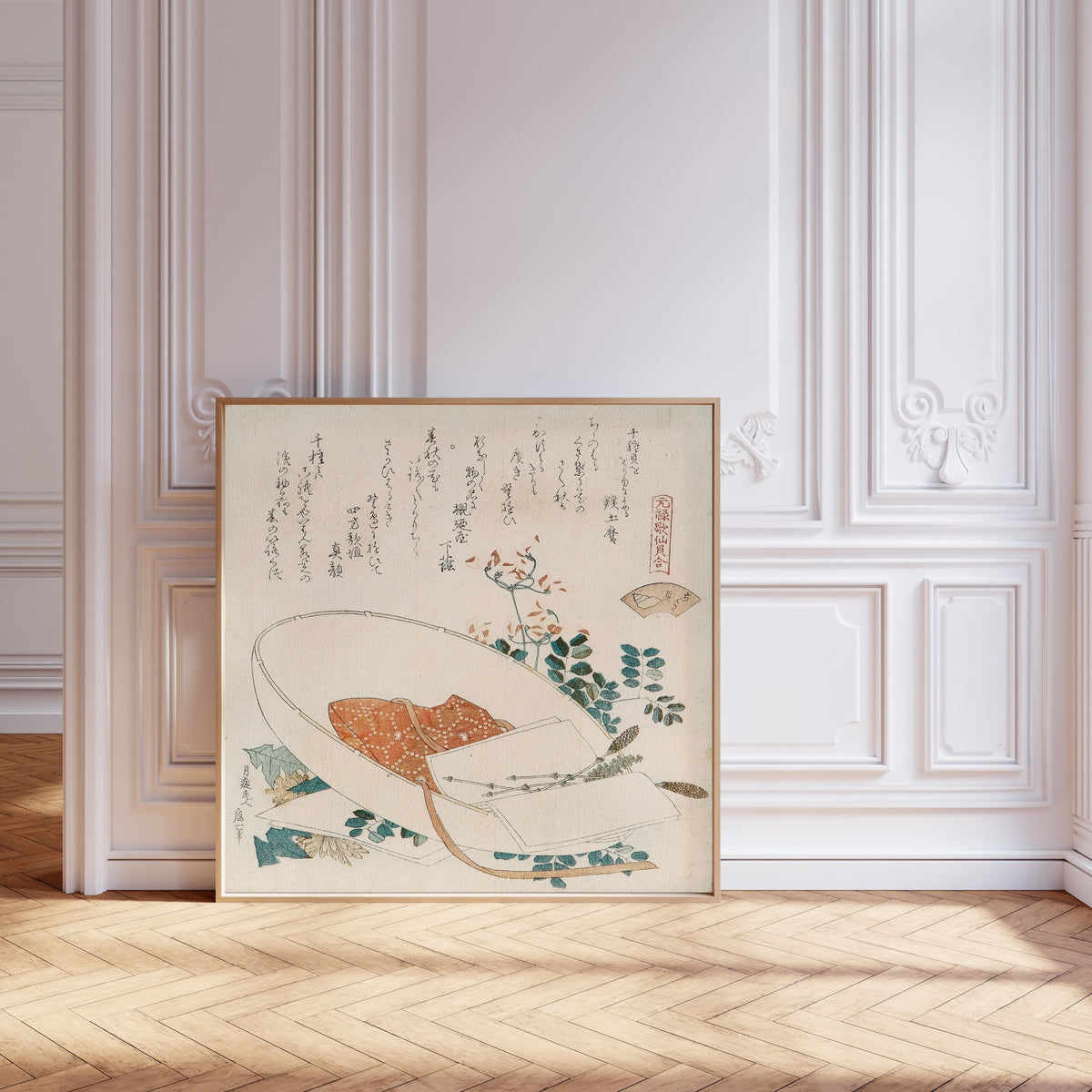 Framed art print of Myriad Grasses Shell by Katsushika Hokusai, leaning against pale pink panelling on a herringbone floor