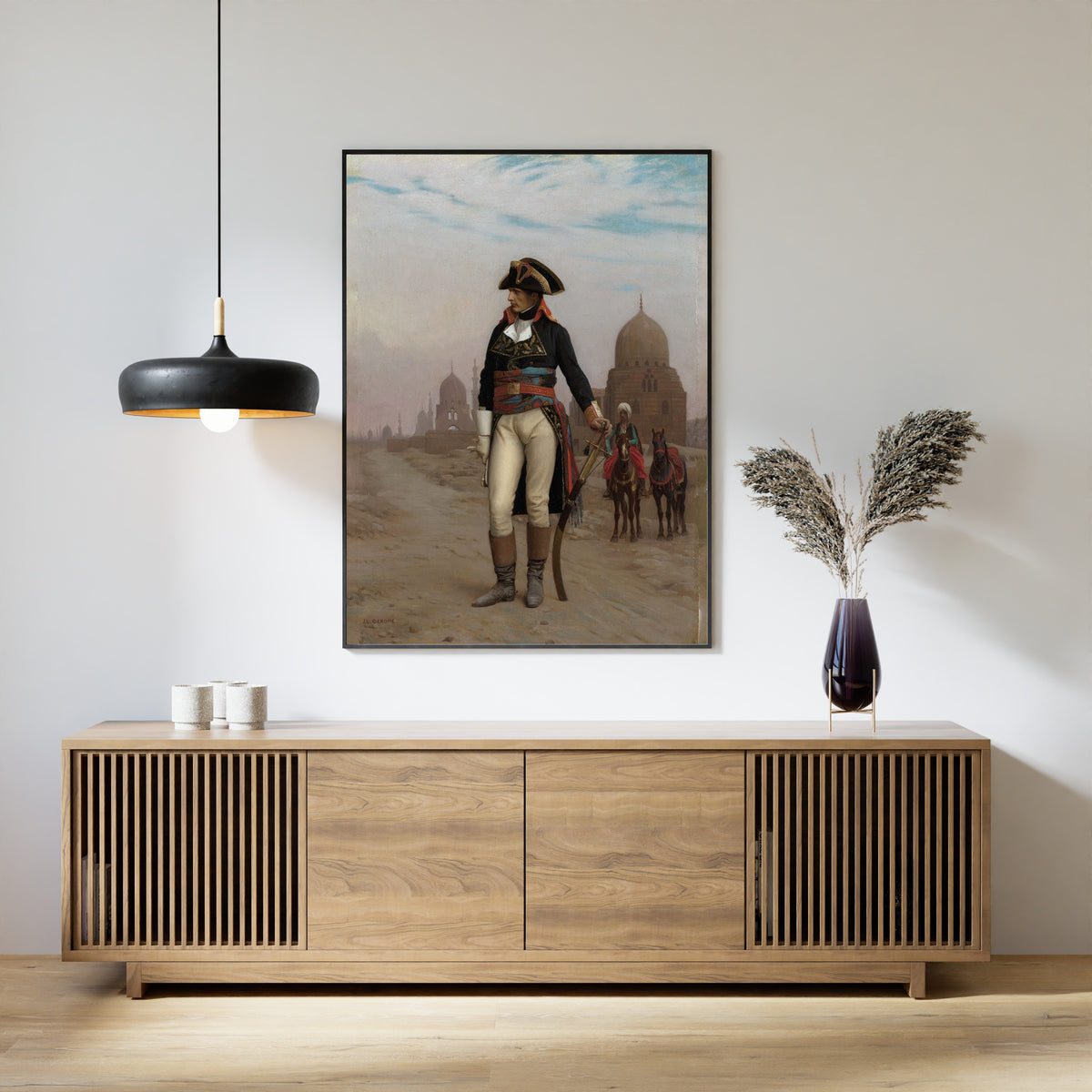 Framed art print of Napoleon in Egypt by Jean-Léon Gérôme, above a slatted wood sideboard