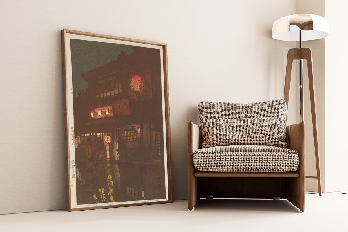 Framed art print of Night in Kyoto by Hiroshi Yoshida, leaning against a wall beside an armchair and a floor lamp
