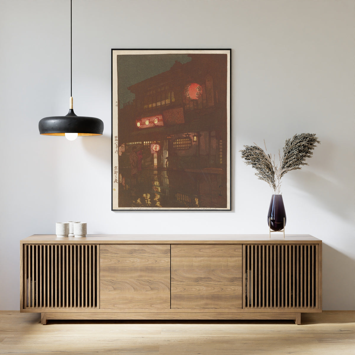Framed art print of Night in Kyoto by Hiroshi Yoshida, above a slatted wood sideboard