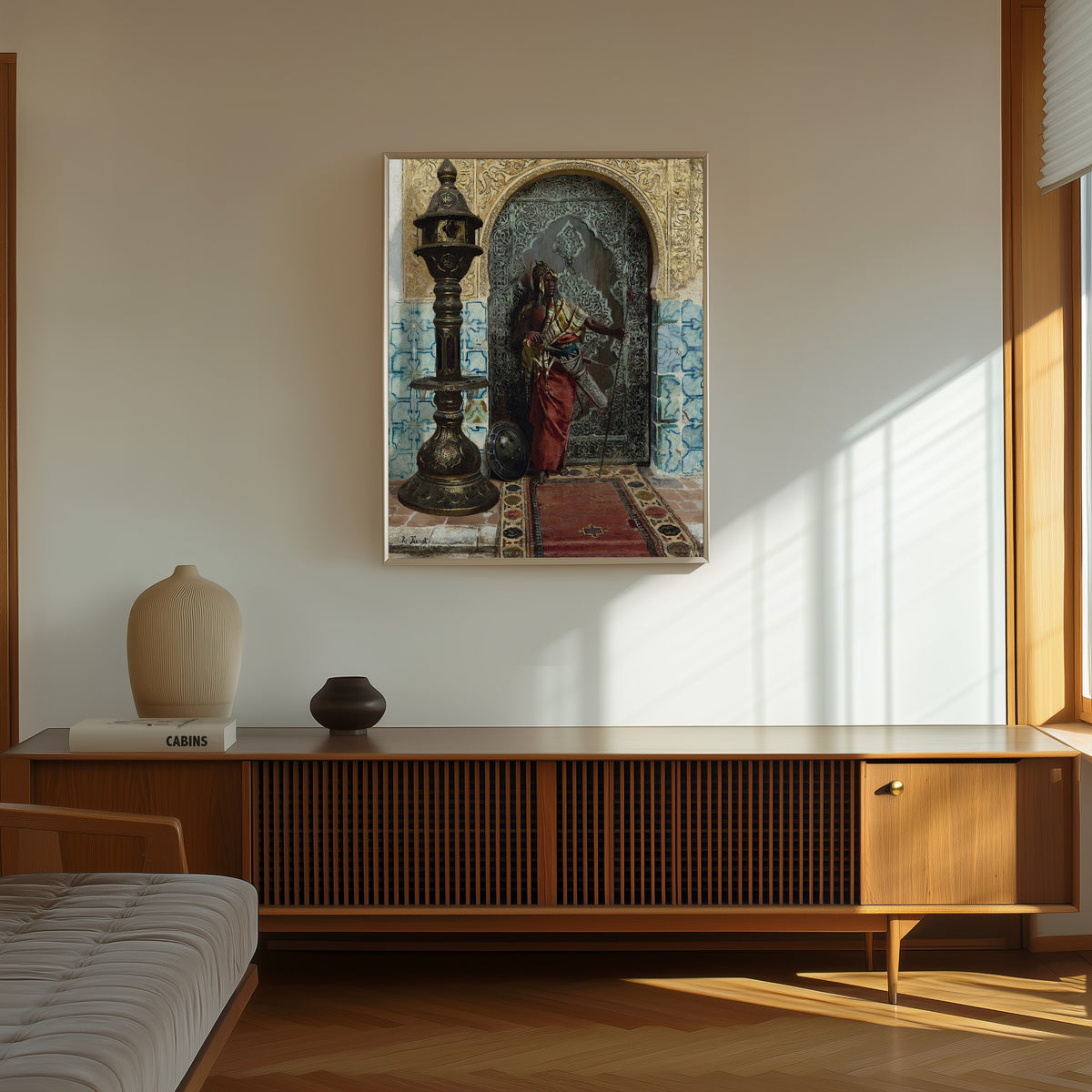 Framed art print of Nubian Guard by Rudolf Ernst, in a thin light frame on a sunlit wall above a wooden sideboard