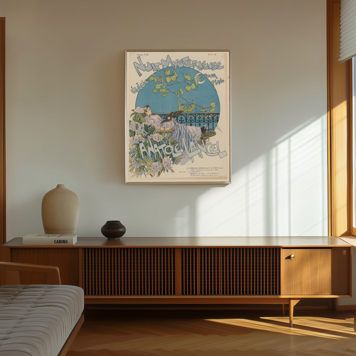 Framed art print of Nuit mystérieuse, élégie pour piano par Anatole… by Théophile Steinlen, in a thin light frame on a sunlit wall above a wooden sideboard