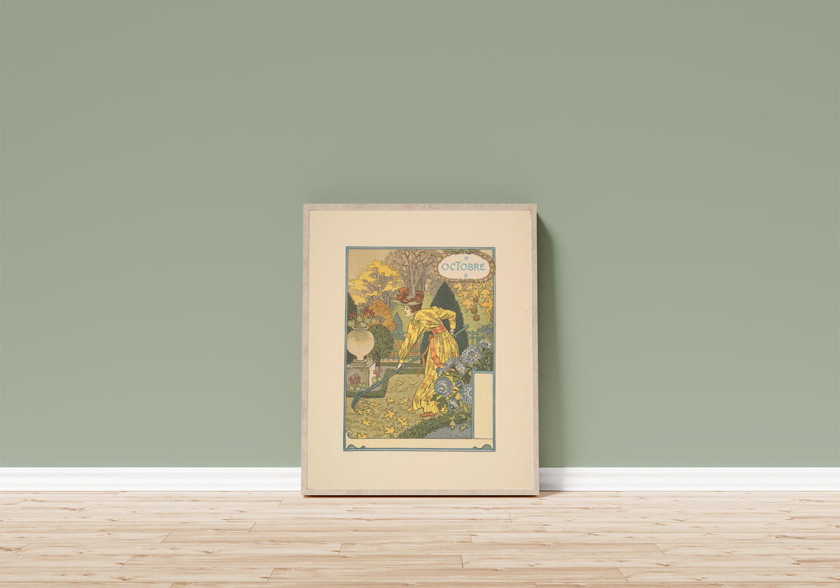 Framed art print of Octobre by Eugène Grasset, in a light wood frame leaning on a sage green wall above a wooden floor