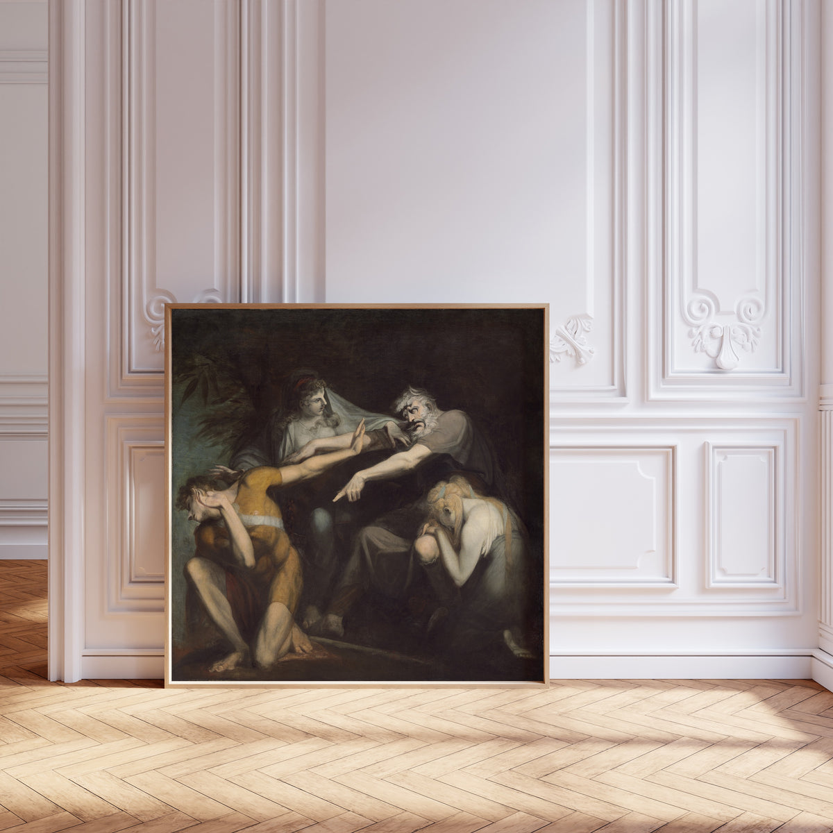 Framed art print of Oedipus Cursing His Son, Polynices by Henry Fuseli, leaning against pale pink panelling on a herringbone floor