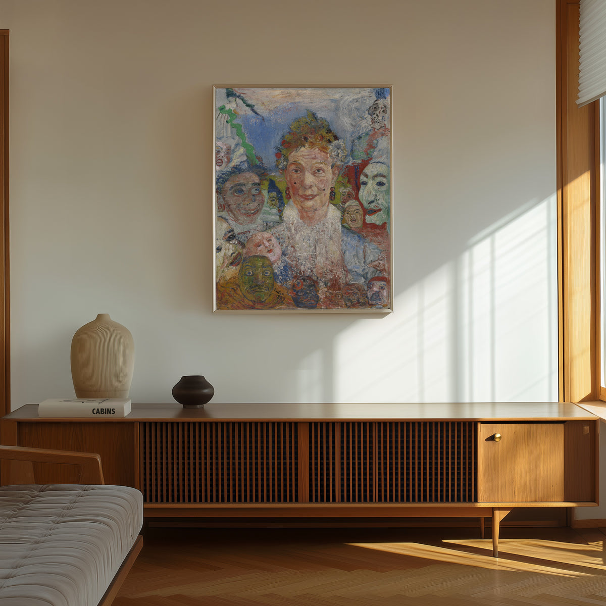 Framed art print of Old Lady with Masks by James Ensor, in a thin light frame on a sunlit wall above a wooden sideboard