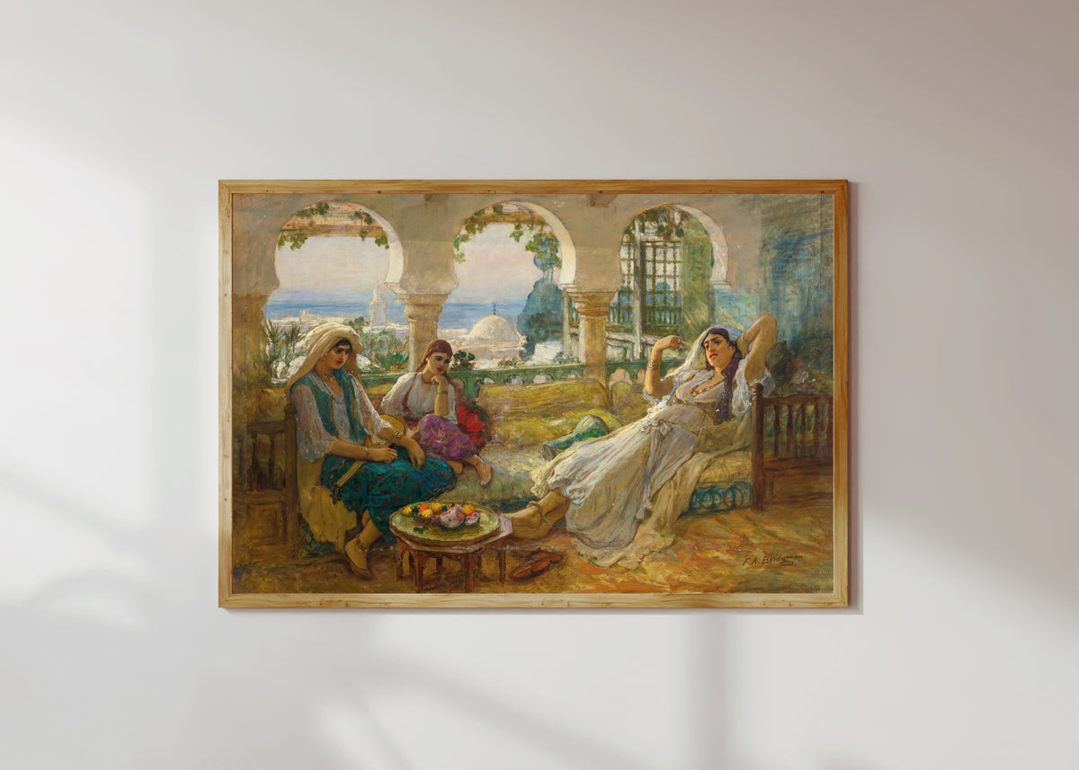 Framed art print of On the Terrace by Frederick Arthur Bridgman, in a light wood frame on a sunlit white wall