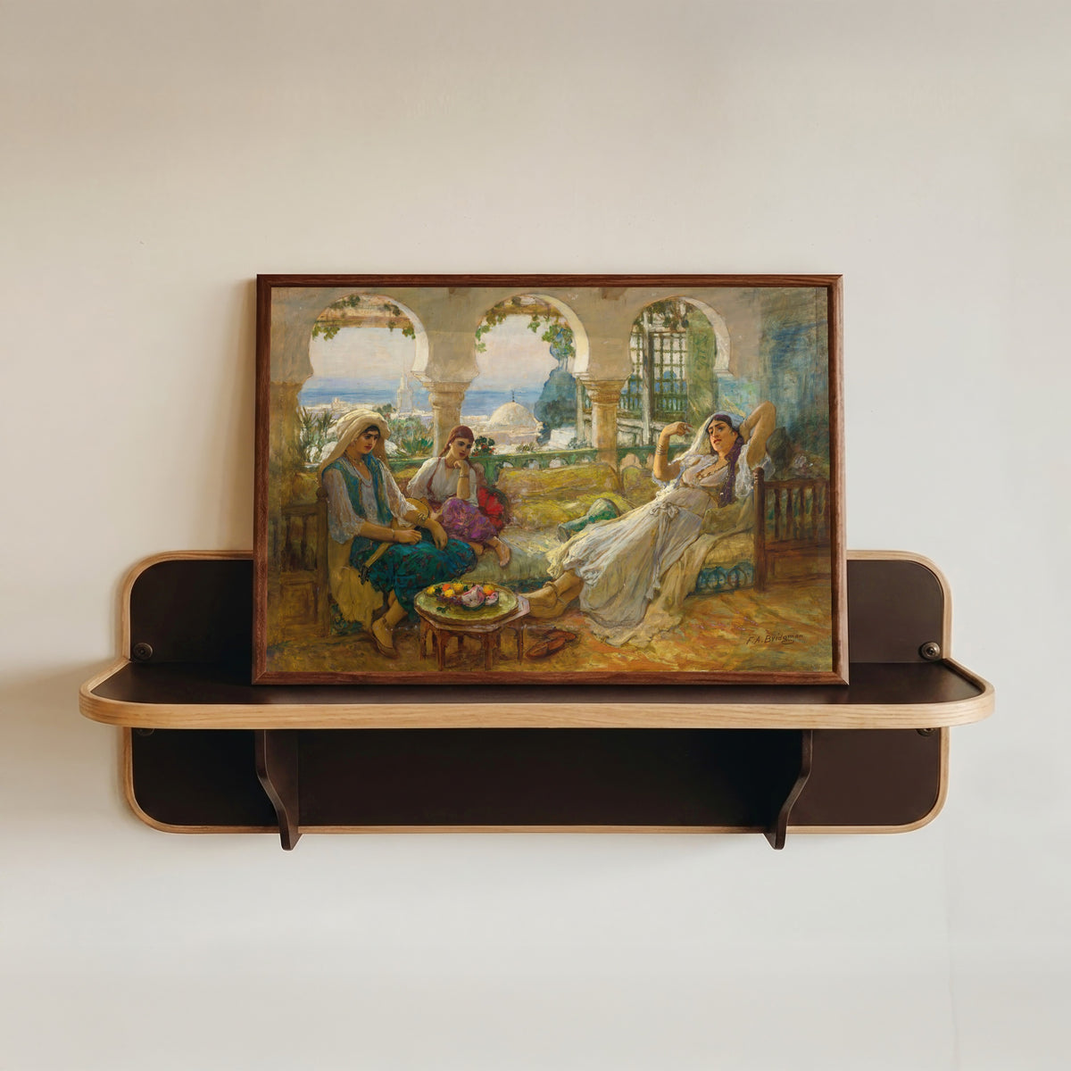 Framed art print of On the Terrace by Frederick Arthur Bridgman, in a dark wood frame resting on a wall shelf