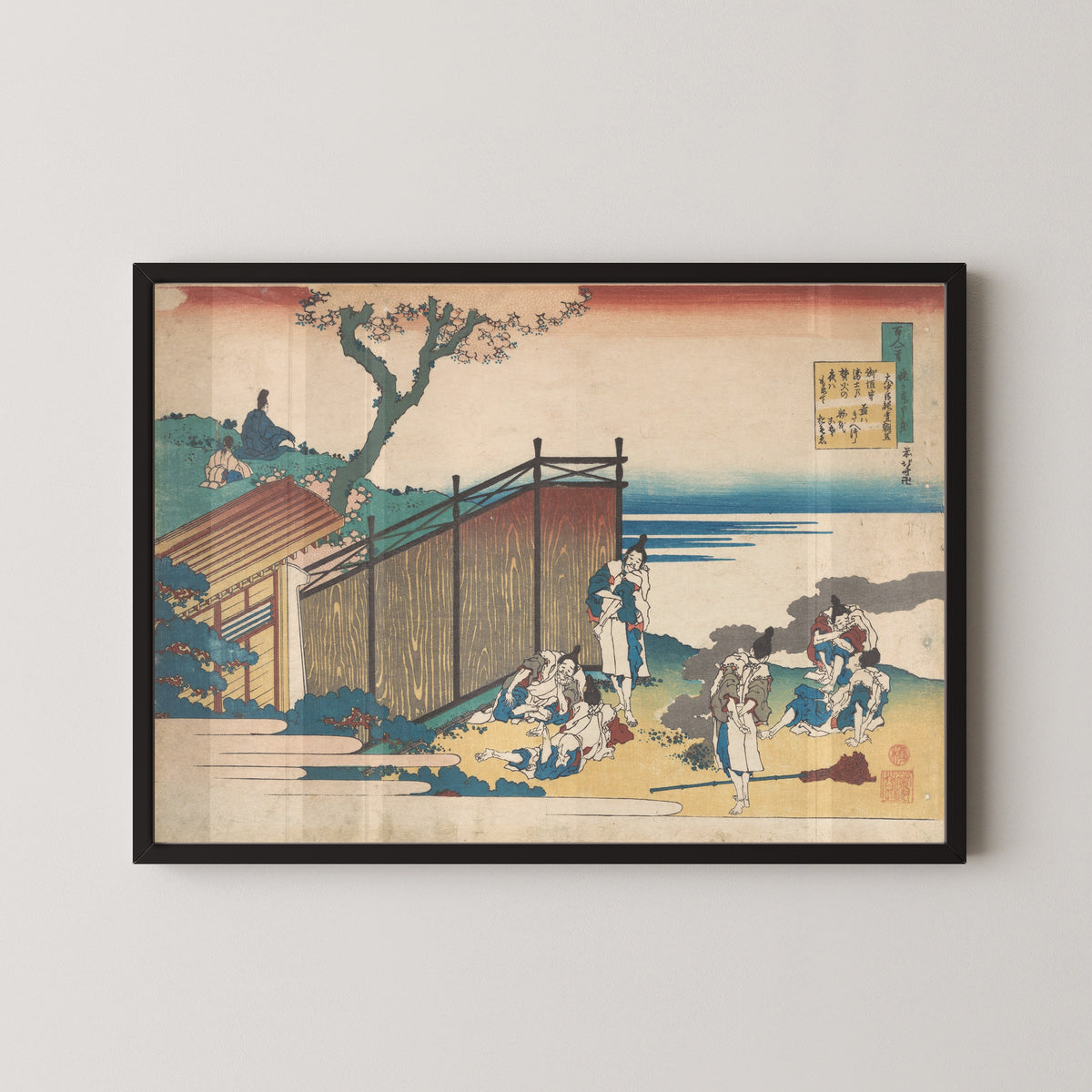 Framed art print of One Hundred Poems Explained by the Nurse: Poem by Ōnakatomi no Yoshinobu Ason by Katsushika Hokusai, in a black frame on a pale wall