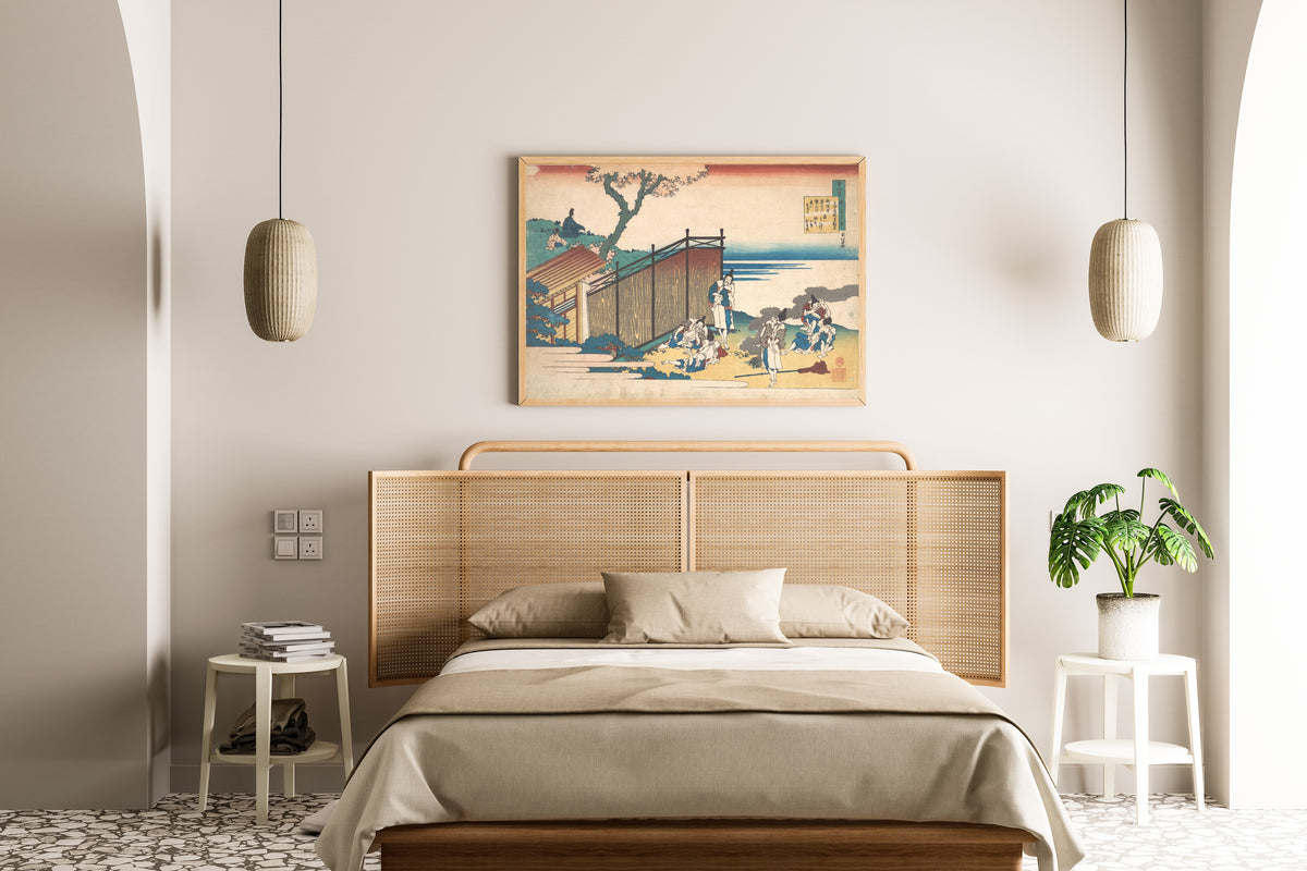 Framed art print of One Hundred Poems Explained by the Nurse: Poem by Ōnakatomi no Yoshinobu Ason by Katsushika Hokusai, above a cane-headboard bed