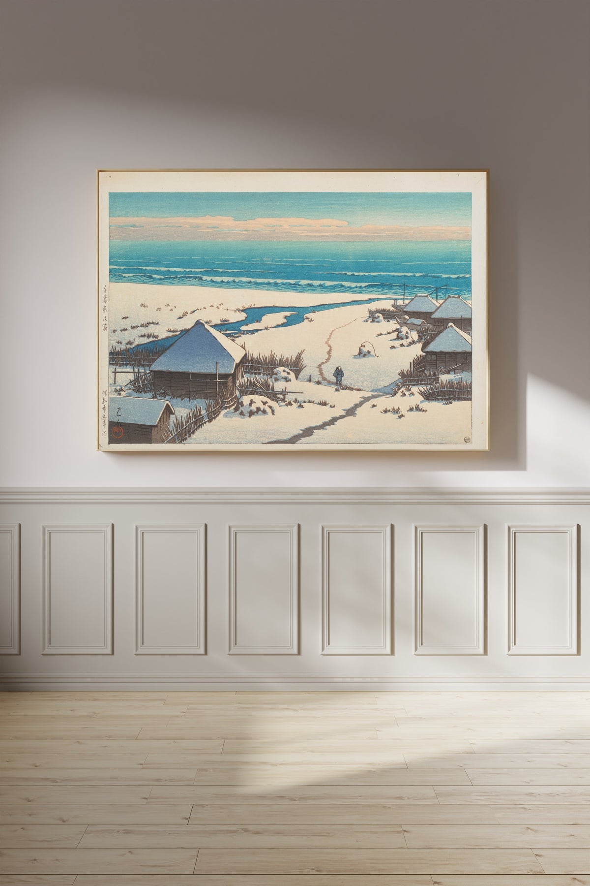 Framed art print of Onjuku, Chiba Prefecture by Kawase Hasui, on a panelled wall in afternoon light