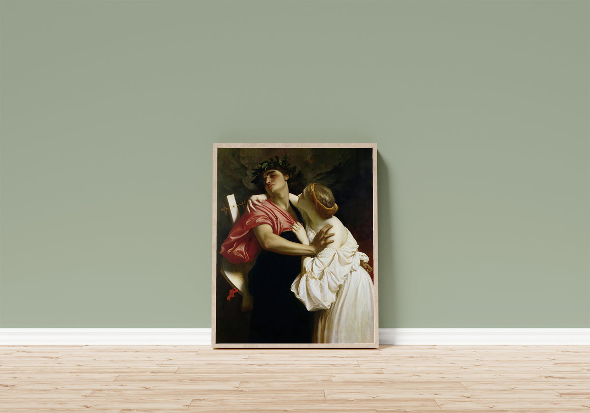 Framed art print of Orpheus and Eurydice by Frederic Leighton, in a light wood frame leaning on a sage green wall above a wooden floor