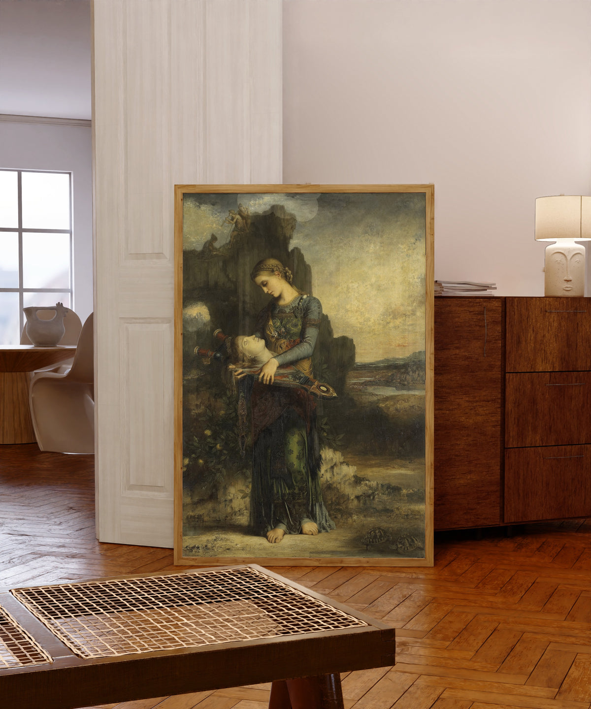 Framed art print of Orpheus by Gustave Moreau, in a light wood frame leaning in a warm room with a parquet floor