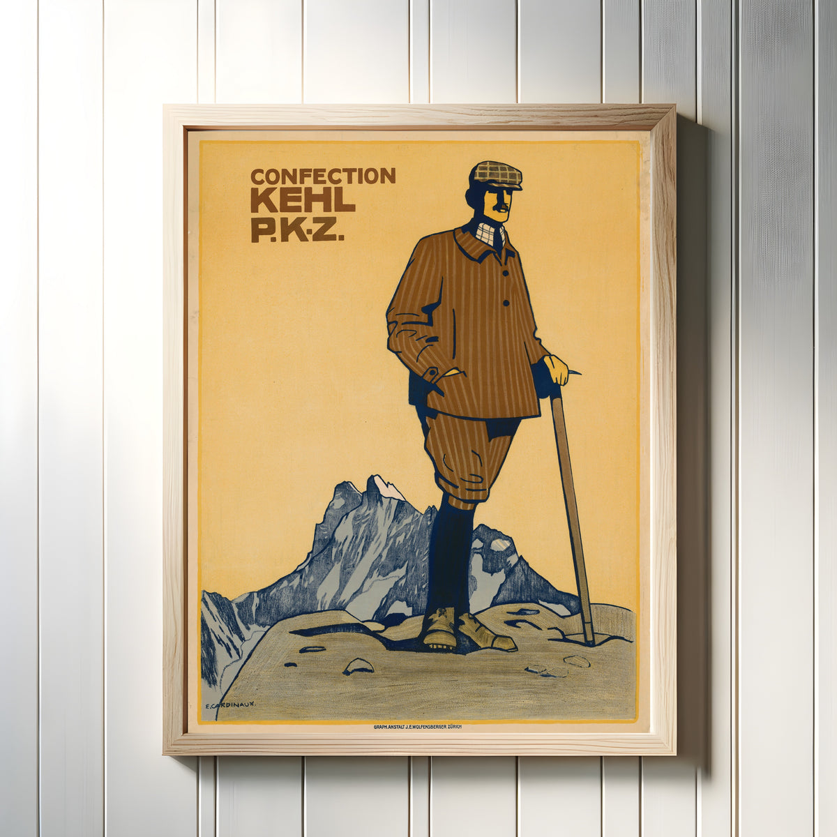 Framed art print of P.K.Z. Confection Kehl by Emil Cardinaux, in a light wood frame on a white panelled wall