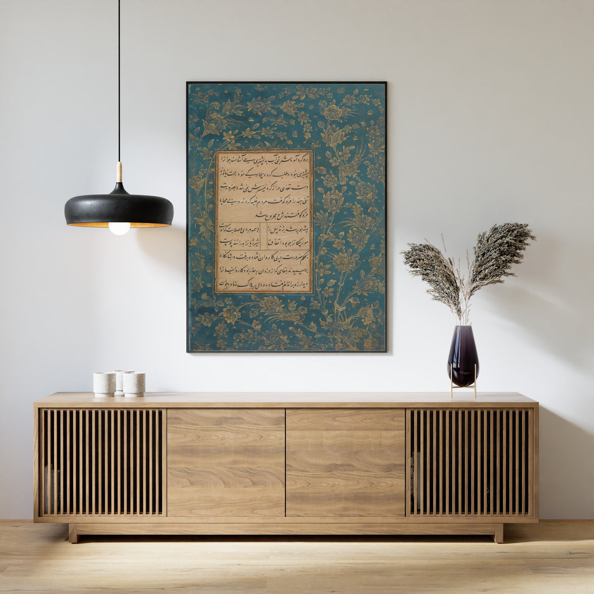 Framed art print of Page of Calligraphy from an Anthology of Poetry by Sa'di and Hafiz by Sultan 'Ali al-Mashhadi, above a slatted wood sideboard