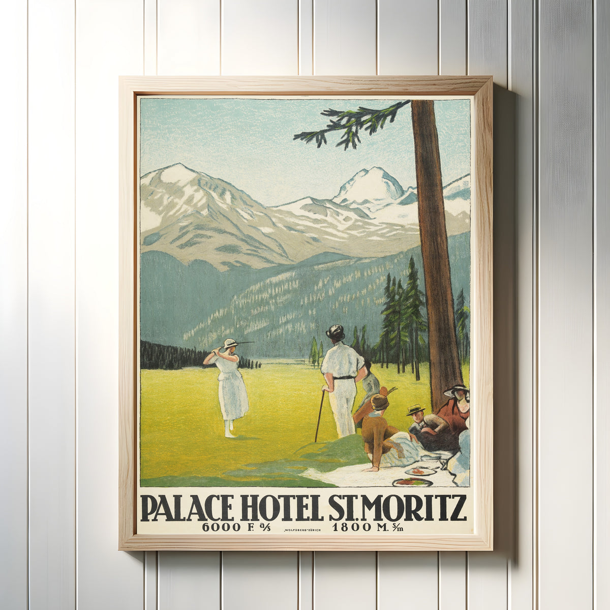 Framed art print of Palace Hotel St. Moritz by Emil Cardinaux, in a light wood frame on a white panelled wall