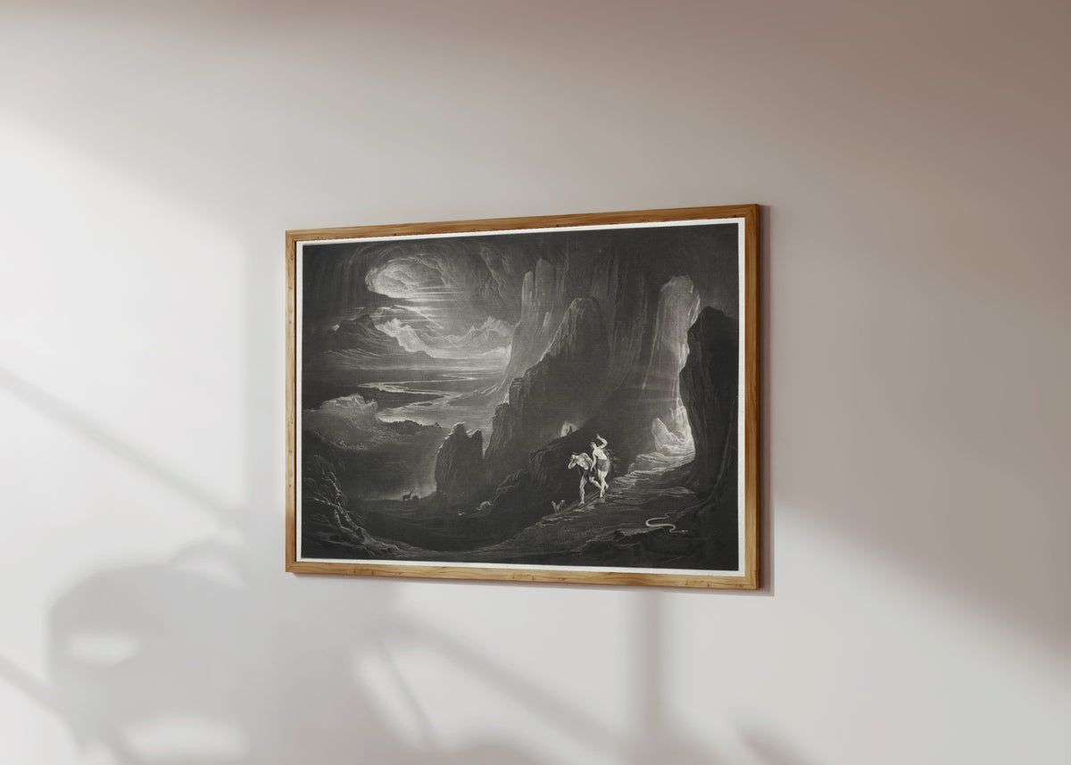 Framed art print of Paradise Lost: Adam and Eve Driven out of Paradise by John Martin, in a light wood frame on a sunlit white wall, seen at a slight angle