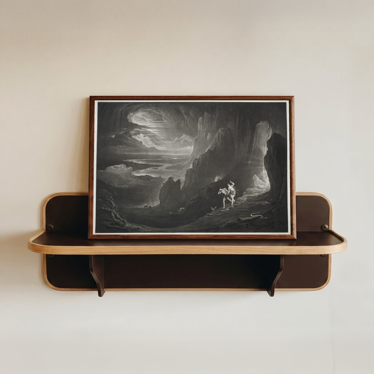 Framed art print of Paradise Lost: Adam and Eve Driven out of Paradise by John Martin, in a dark wood frame resting on a wall shelf