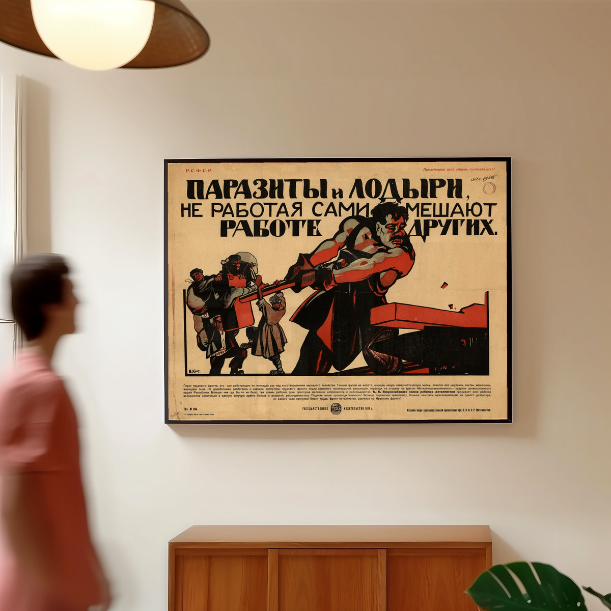 Framed art print of Parasites and Idlers, by Not Working, Themselves Hinder the… by Vasily Kostyanitsyn, in a slim black frame on a warm wall in a sunlit room
