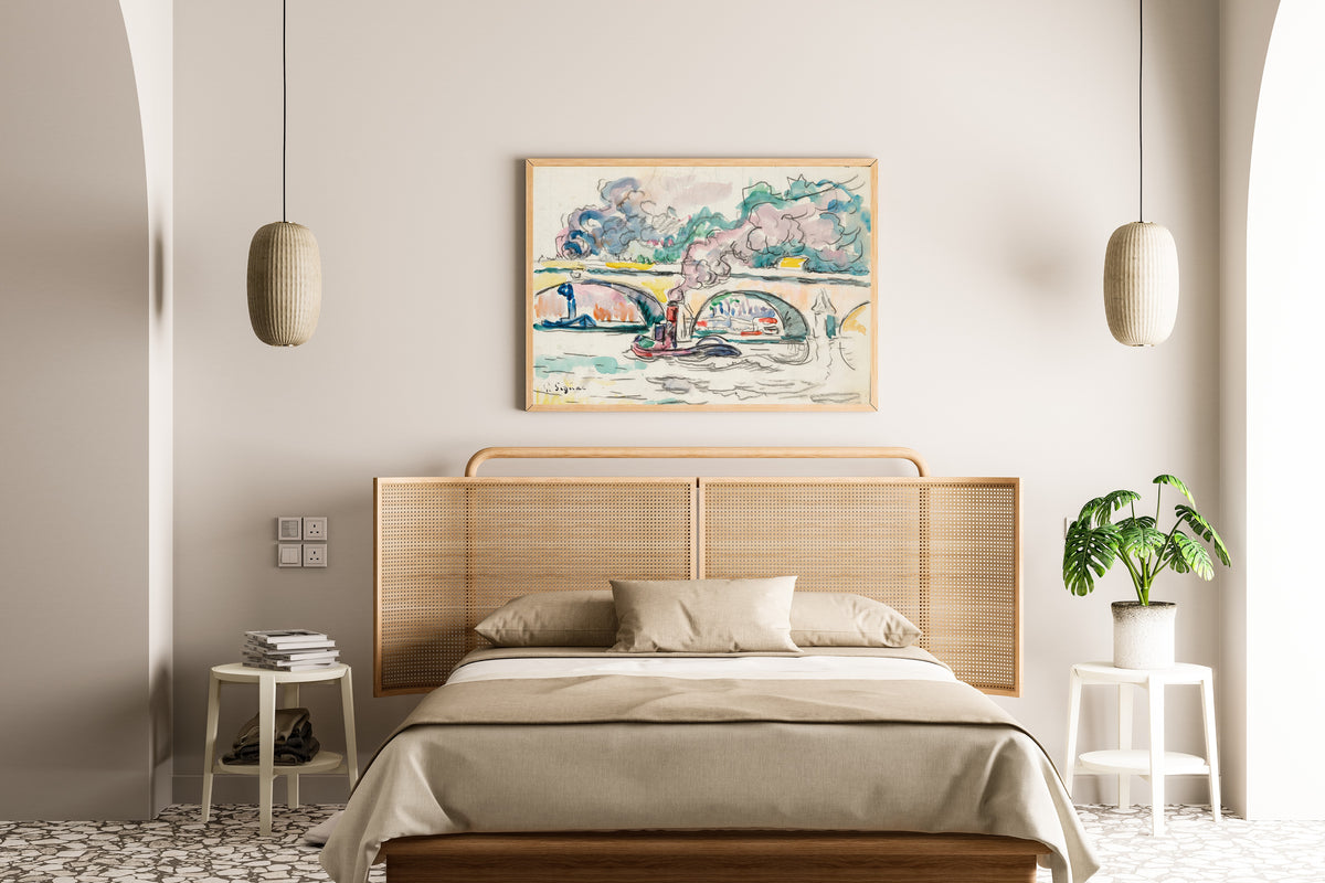 Framed art print of Paris, Le Pont-Royal by Paul Signac, above a cane-headboard bed
