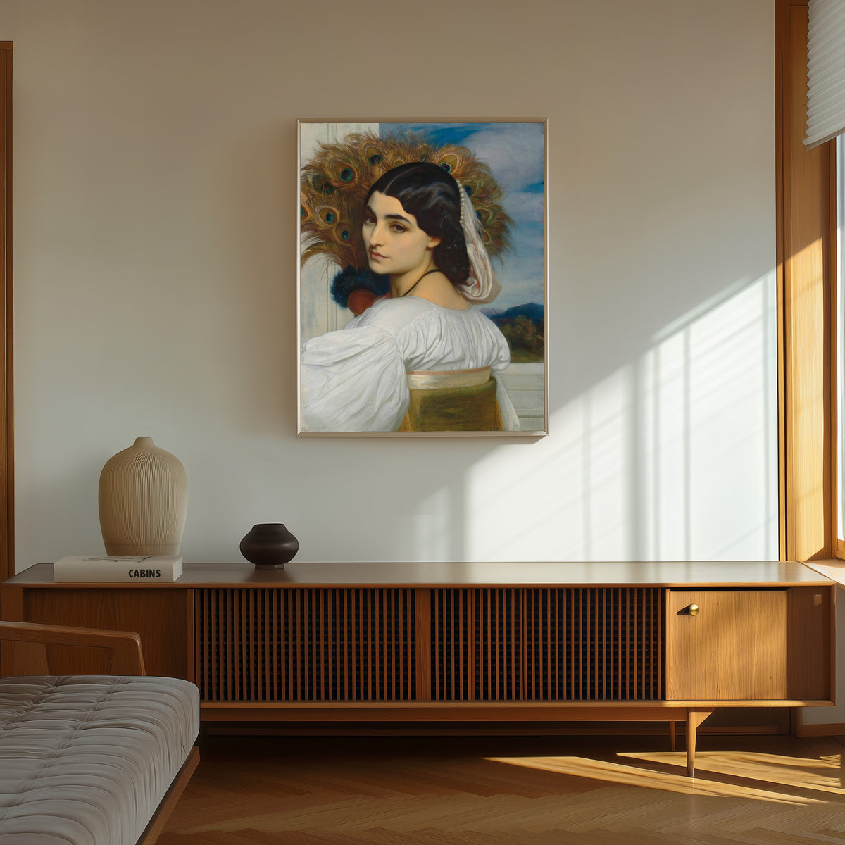Framed art print of Pavonia by Frederic Leighton, in a thin light frame on a sunlit wall above a wooden sideboard