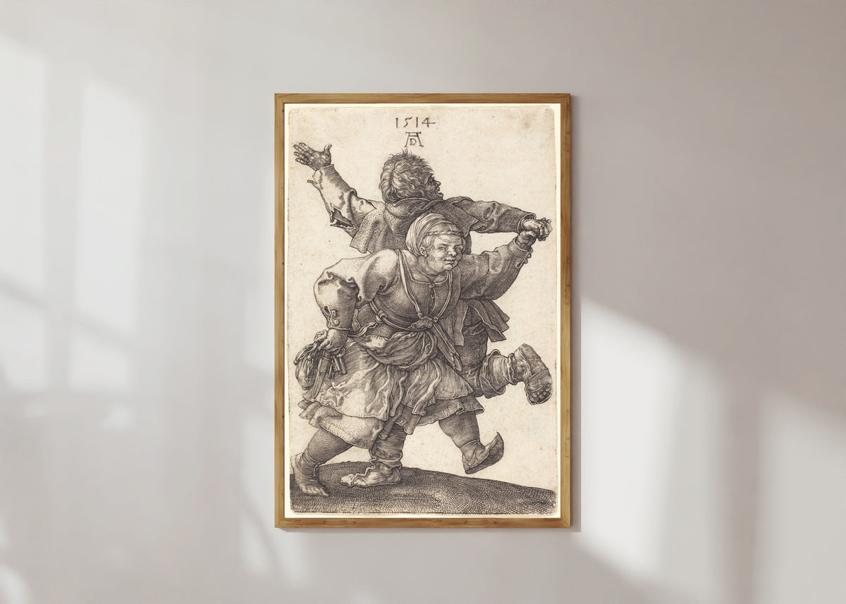 Framed art print of Peasant Couple Dancing by Albrecht Dürer, in a light wood frame on a sunlit white wall