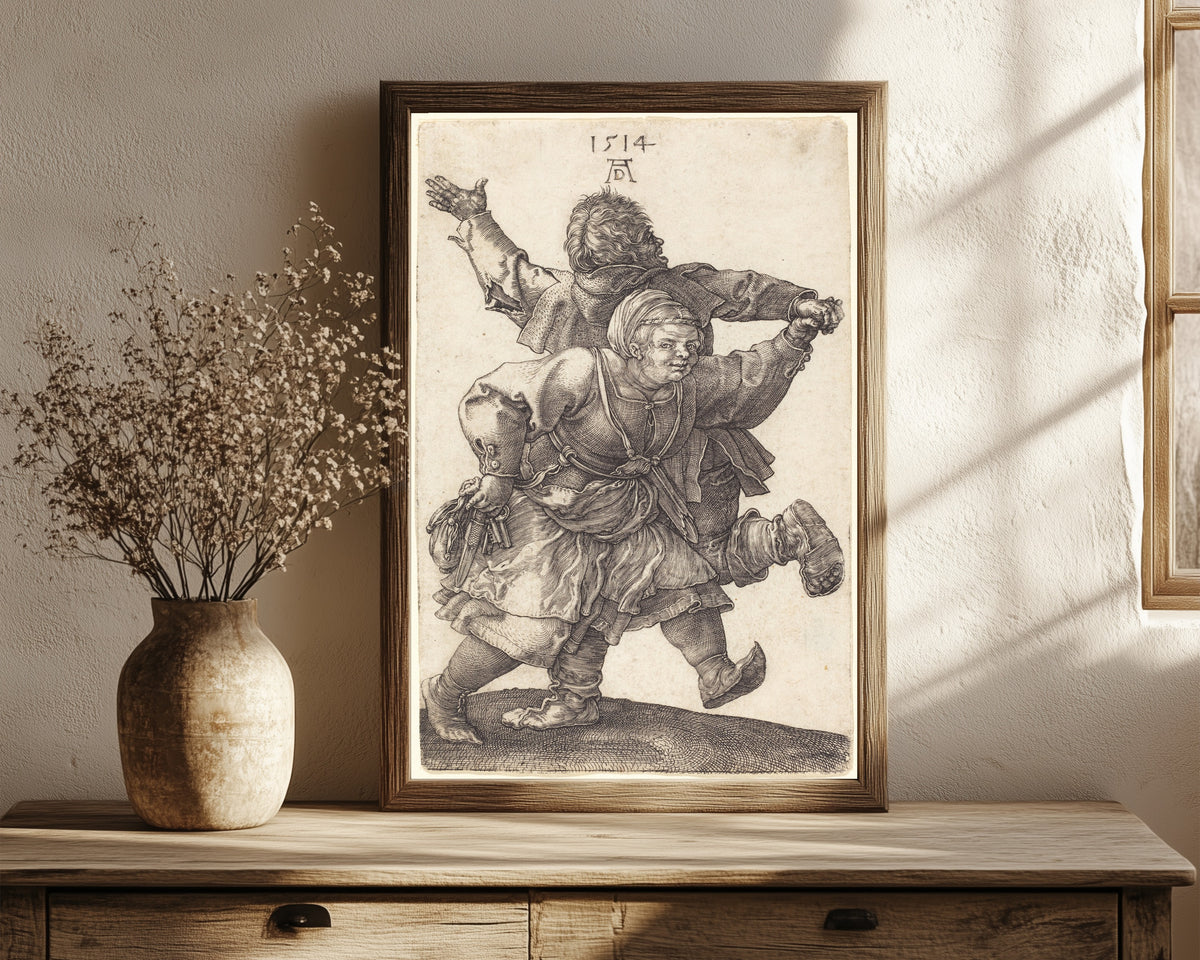 Framed art print of Peasant Couple Dancing by Albrecht Dürer, in a dark wood frame leaning on a rustic console beside dried flowers