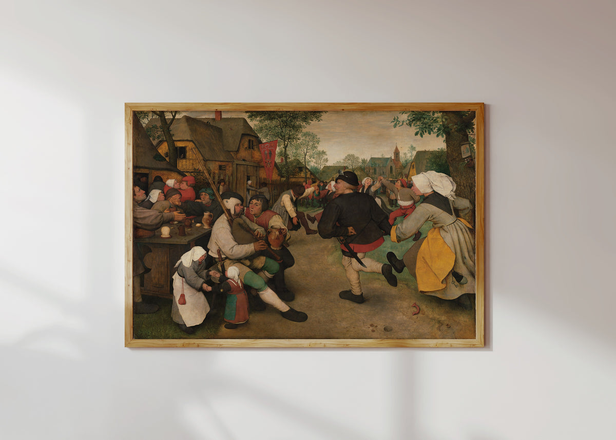 Framed art print of Peasant Dance by Pieter Bruegel the Elder, in a light wood frame on a sunlit white wall