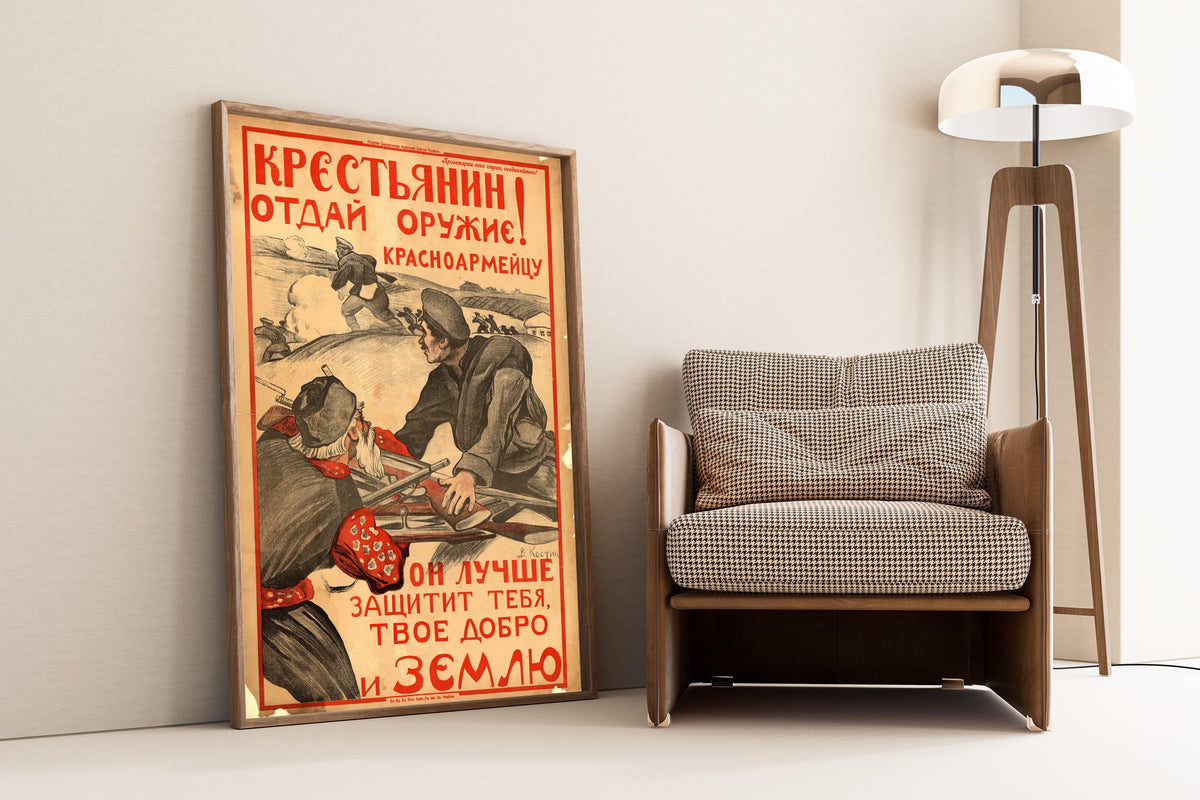 Framed art print of Peasant! Give Your Weapon to the Red Army Soldier by Vasily Kostyanitsyn, leaning against a wall beside an armchair and a floor lamp
