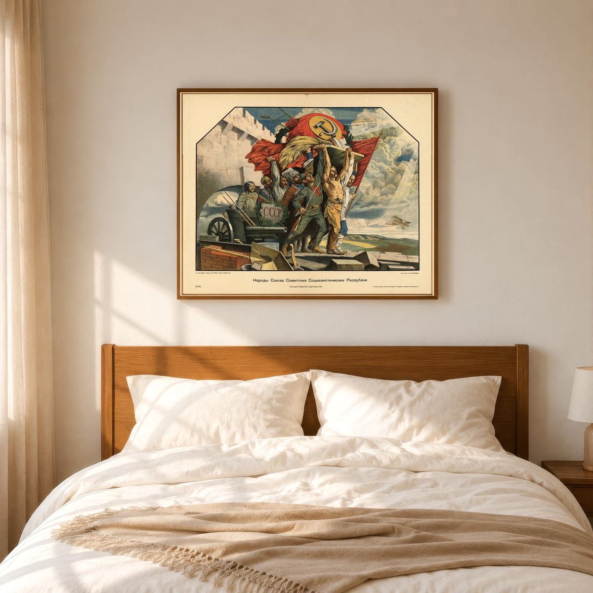 Framed art print of Peoples of the Union of Soviet Socialist Republics by Stepan Karpov, in a slim wood frame above a bed in a sunlit bedroom