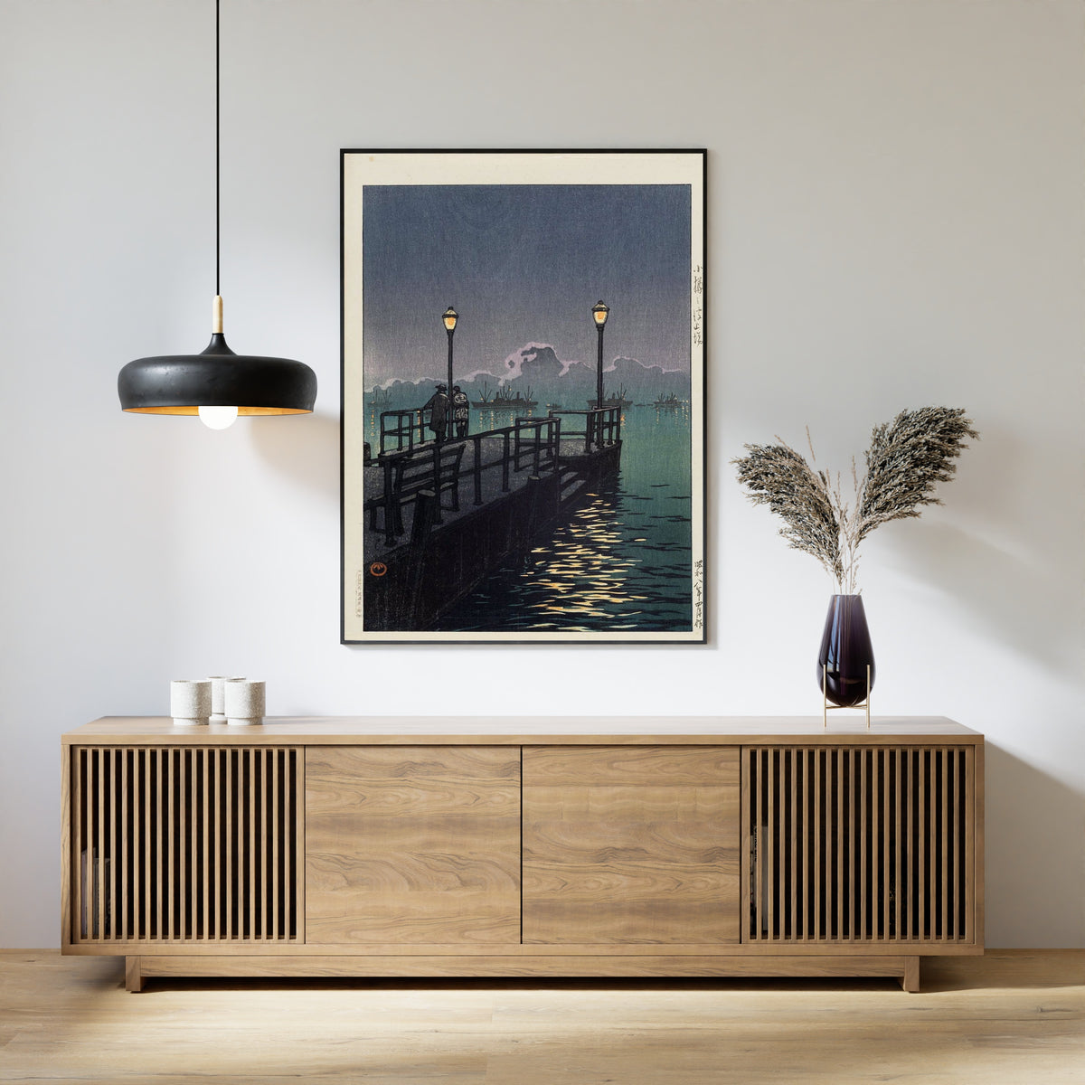 Framed art print of Pier at Otaru by Kawase Hasui, above a slatted wood sideboard