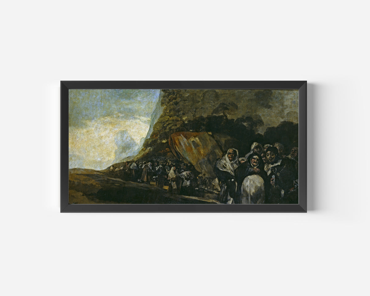 Framed art print of Pilgrimage to the Fountain of San Isidro by Francisco de Goya, in a wide black frame on a plain white wall