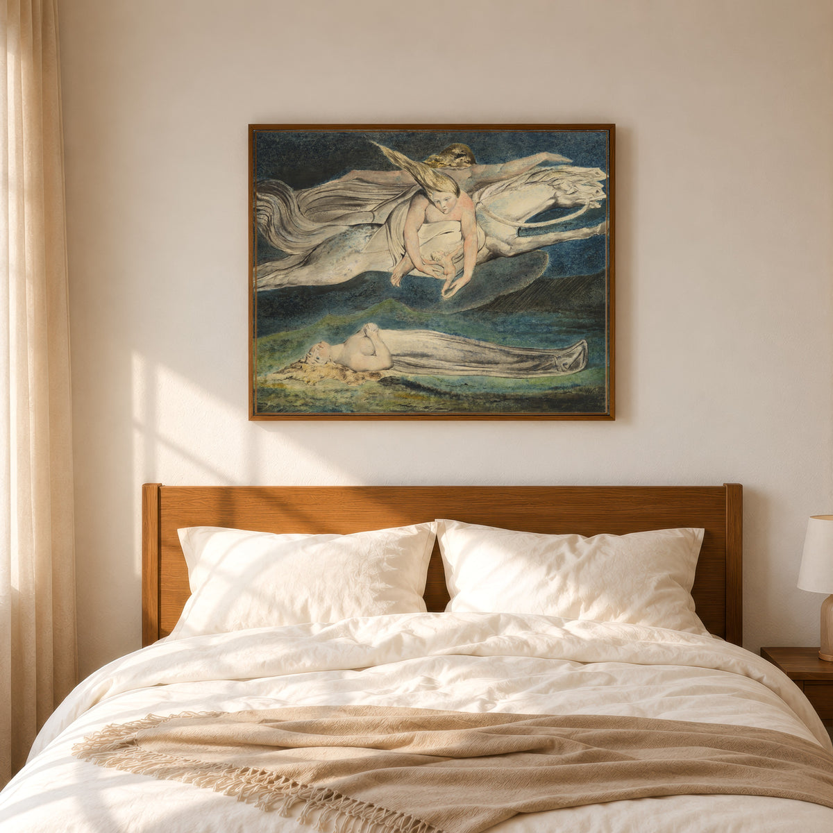 Framed art print of Pity by William Blake, in a slim wood frame above a bed in a sunlit bedroom