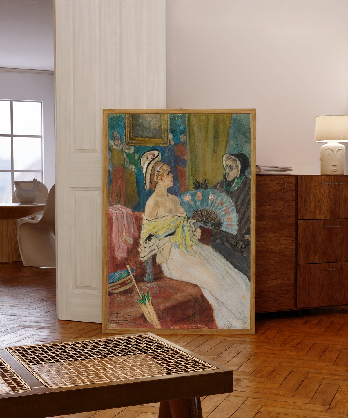 Framed art print of Plénipotentiaire by Félicien Rops, in a light wood frame leaning in a warm room with a parquet floor