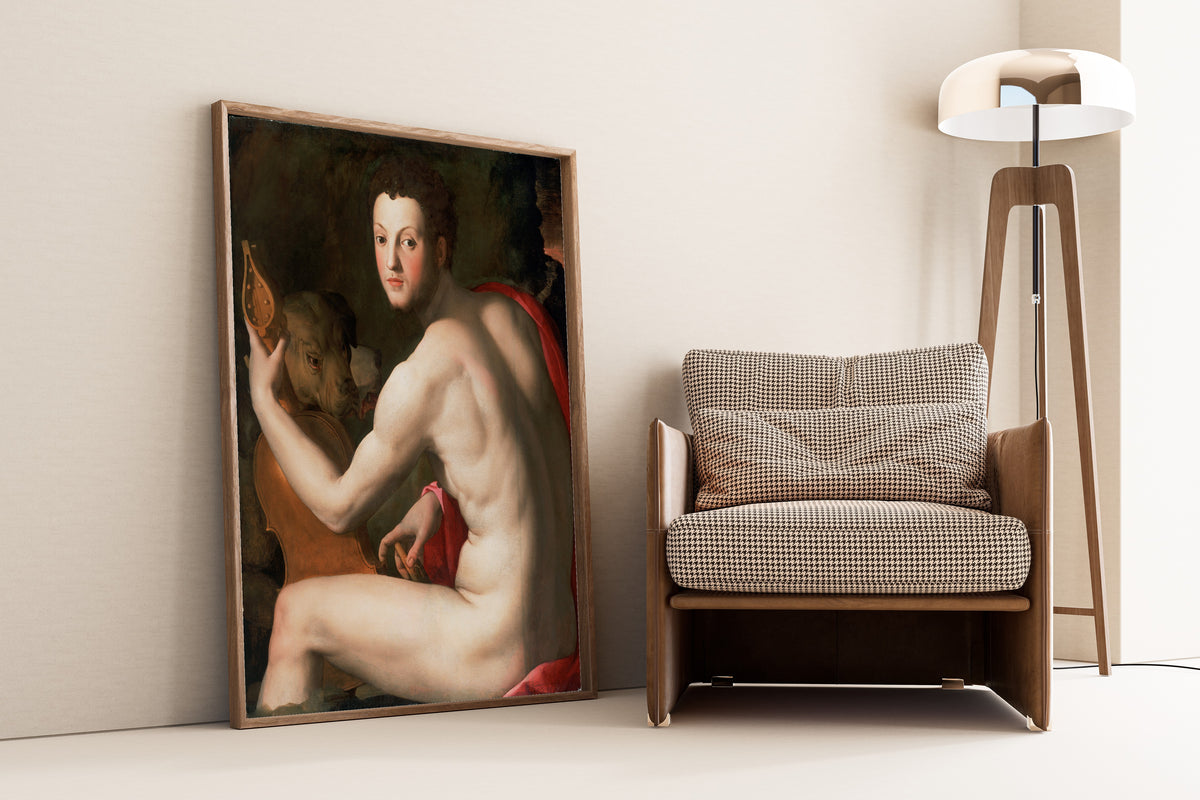 Framed art print of Portrait of Cosimo I de’ Medici as Orpheus by Bronzino, leaning against a wall beside an armchair and a floor lamp