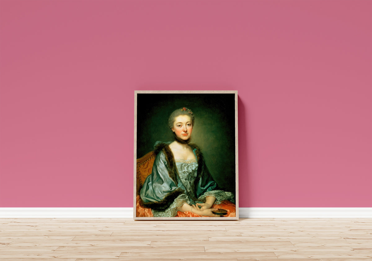 Framed art print of Portrait of Marie Angélique Vérany de Varennes… by Jean-Baptiste Greuze, in a light wood frame leaning on a pink wall above a wooden floor