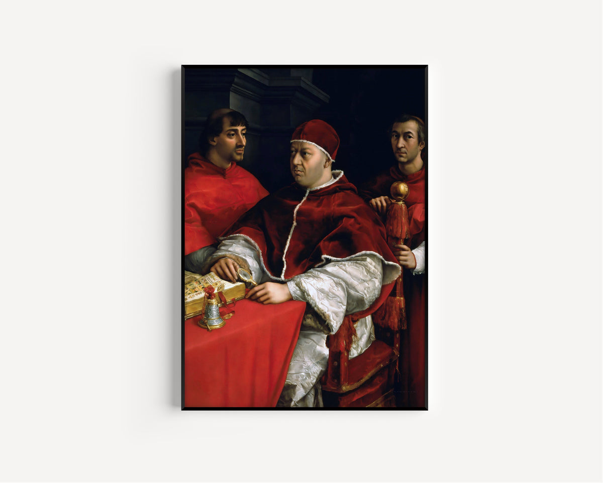 Framed art print of Portrait of Pope Leo X with Cardinals Giulio de’ Medici and Luigi de’ Rossi by Raphael, in a slim black frame on a plain white wall