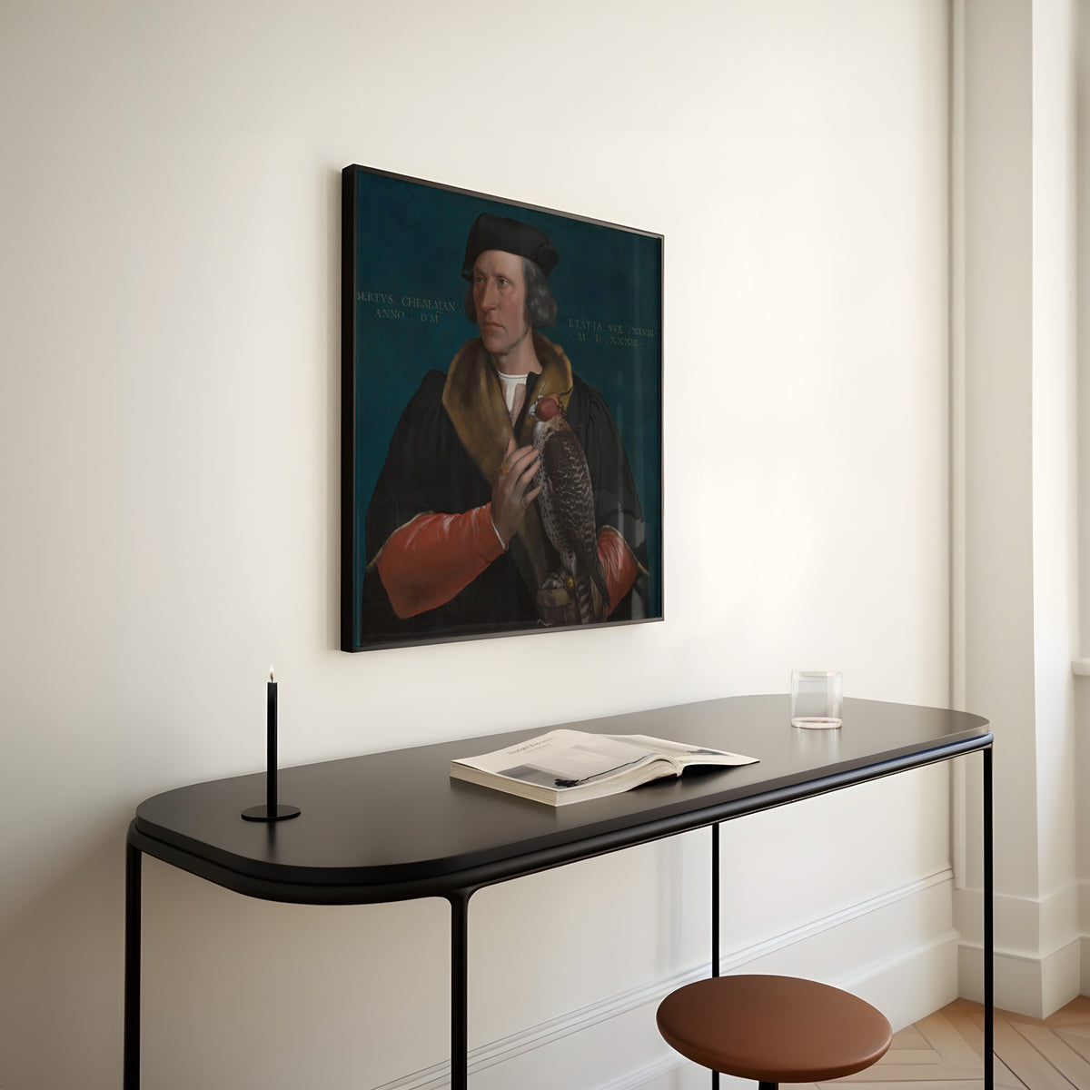 Framed art print of Portrait of Robert Cheseman by Hans Holbein the Younger, above a slim black console table