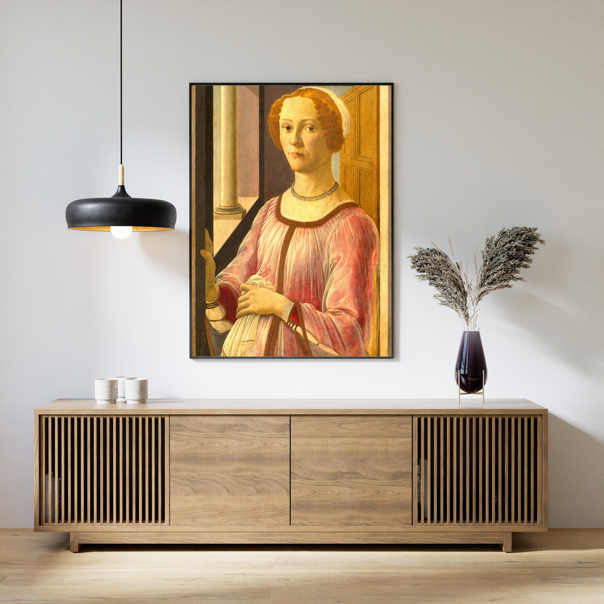 Framed art print of Portrait of Smeralda Bandinelli by Sandro Botticelli, above a slatted wood sideboard